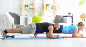 Overweight couple doing exercises at home